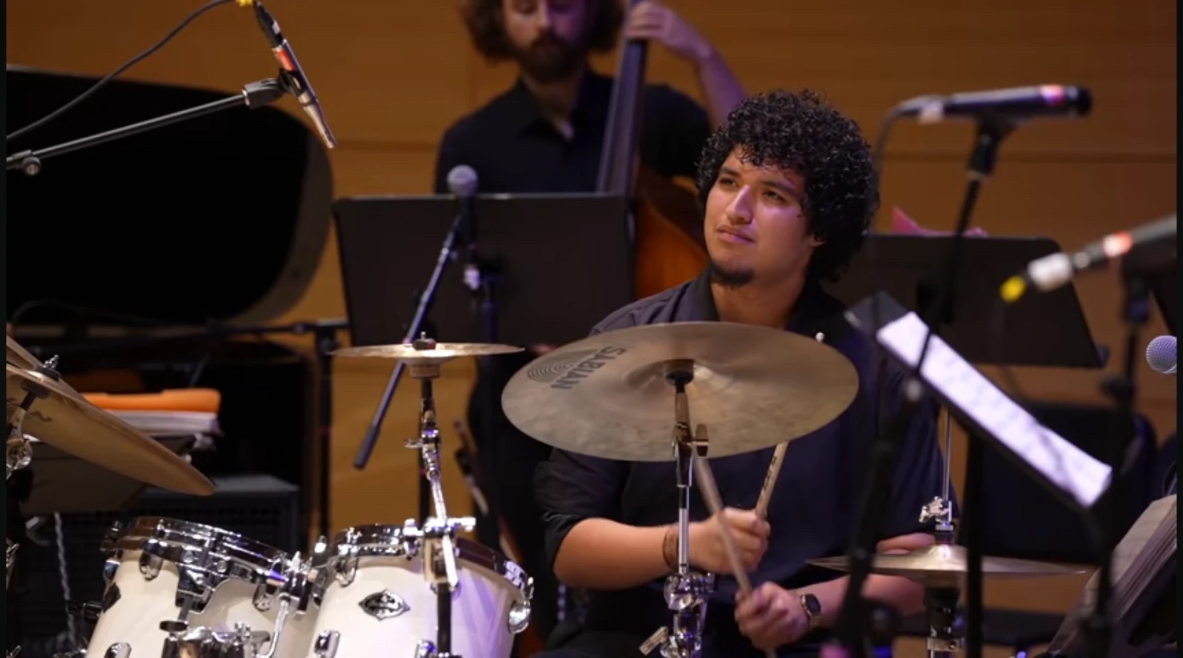 Joaquin Ortiz at the kit on a concert hall stage